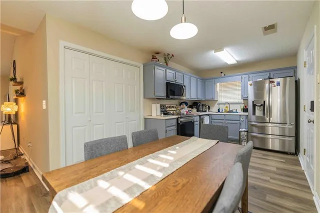 a kitchen with granite countertop stainless steel appliances and wooden cabinets