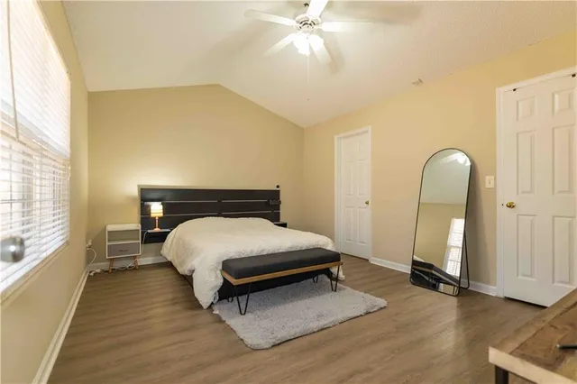 a bedroom with a bed and wooden floor