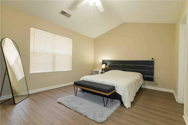 a bedroom with a bed and a window