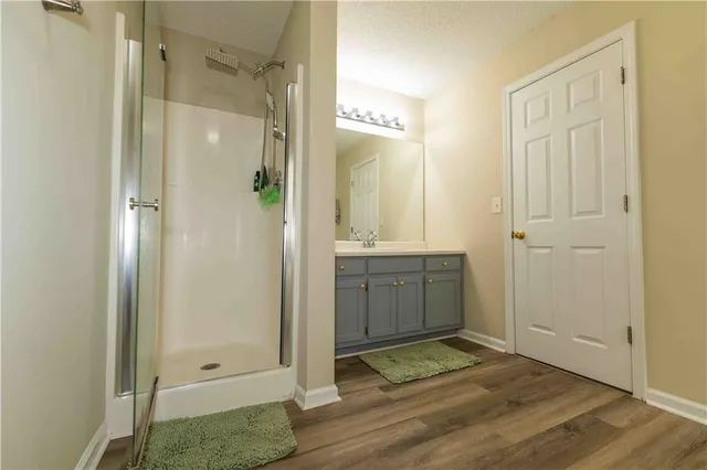 a bathroom with a shower and a sink