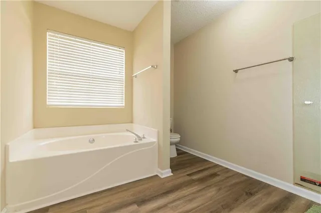 a bathroom with a bathtub and a window
