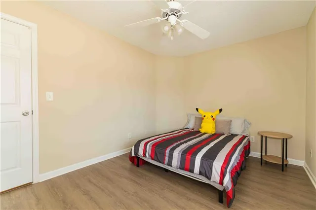 a bedroom with a bed and wooden floor