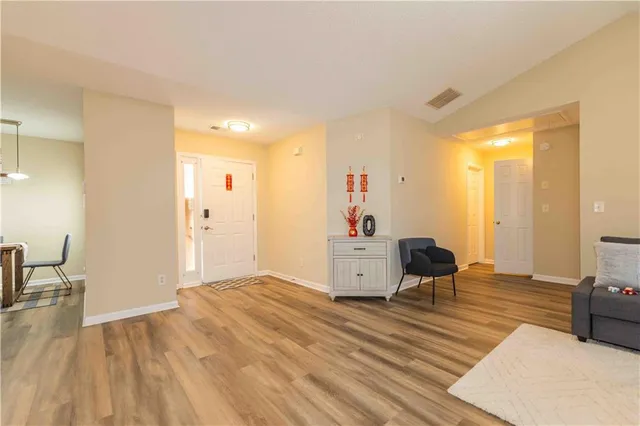 a living room with furniture and a wooden floor