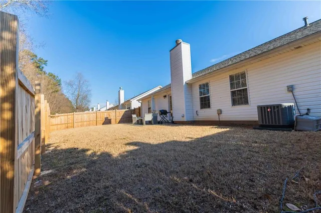 a view of a house with wooden fence