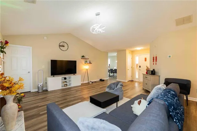 a living room with furniture and a flat screen tv