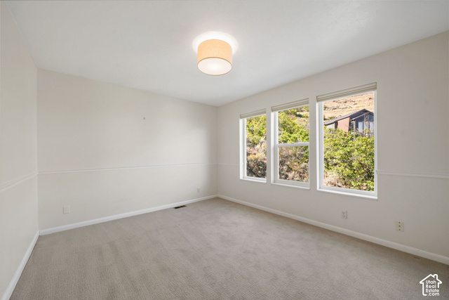 380 Luzern Road Midway, UT 84049 - Photo 14 of 41 Light-filled room featuring a vaulted ceiling, recessed lighting, and three large windows