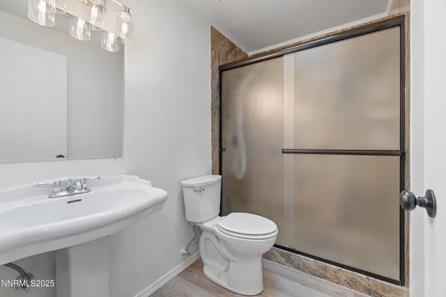 a white toilet sitting next to a bathroom sink