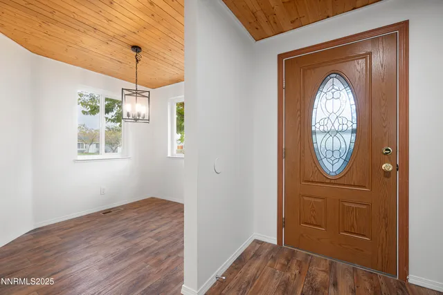 a view of a hallway with entryway wooden floor and front door