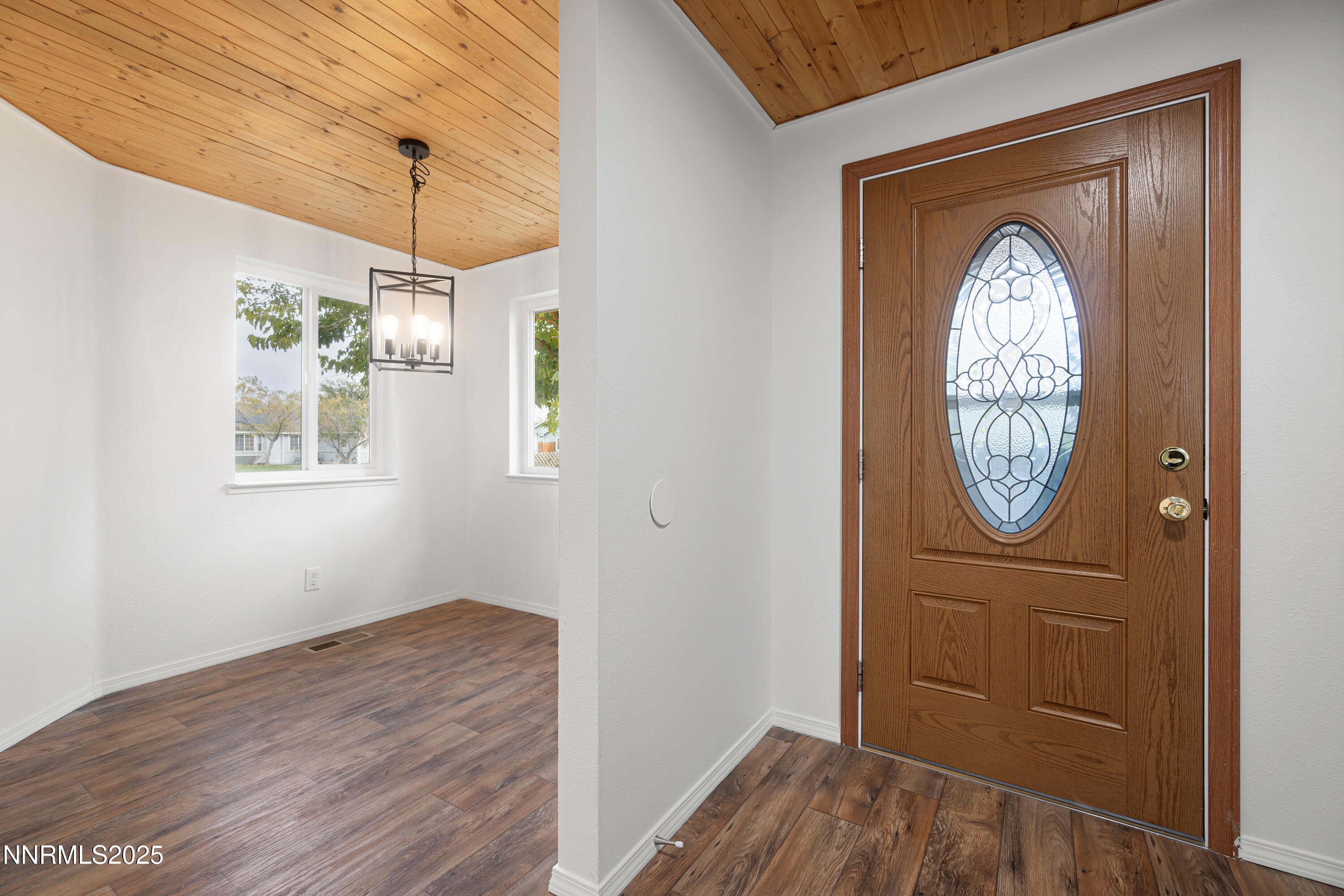365 Kathy Street Fallon, NV 89406 - Photo 9 of 28 a view of a hallway with entryway wooden floor and front door