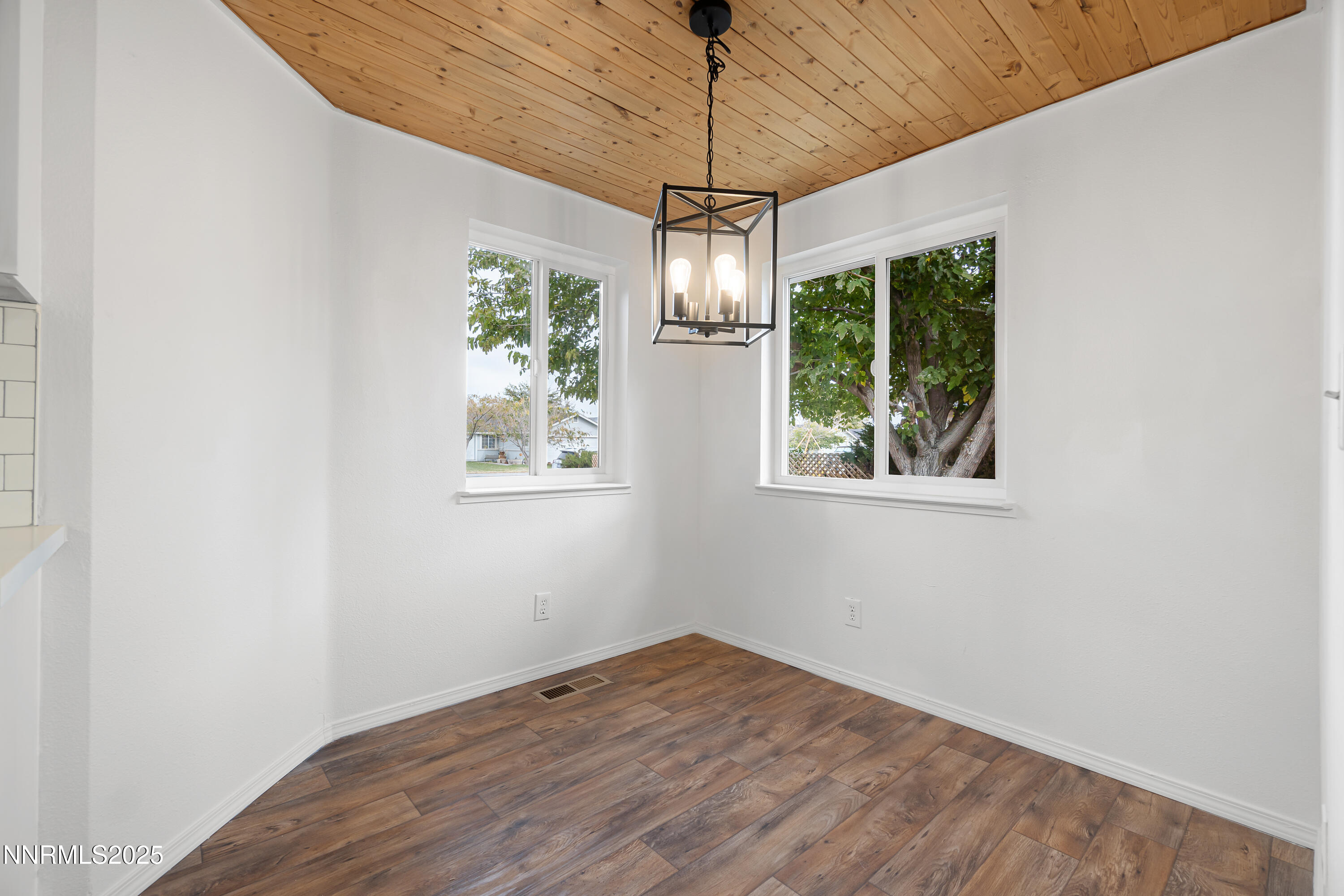 365 Kathy Street Fallon, NV 89406 - Photo 10 of 28 a view of empty room with wooden floor and windows