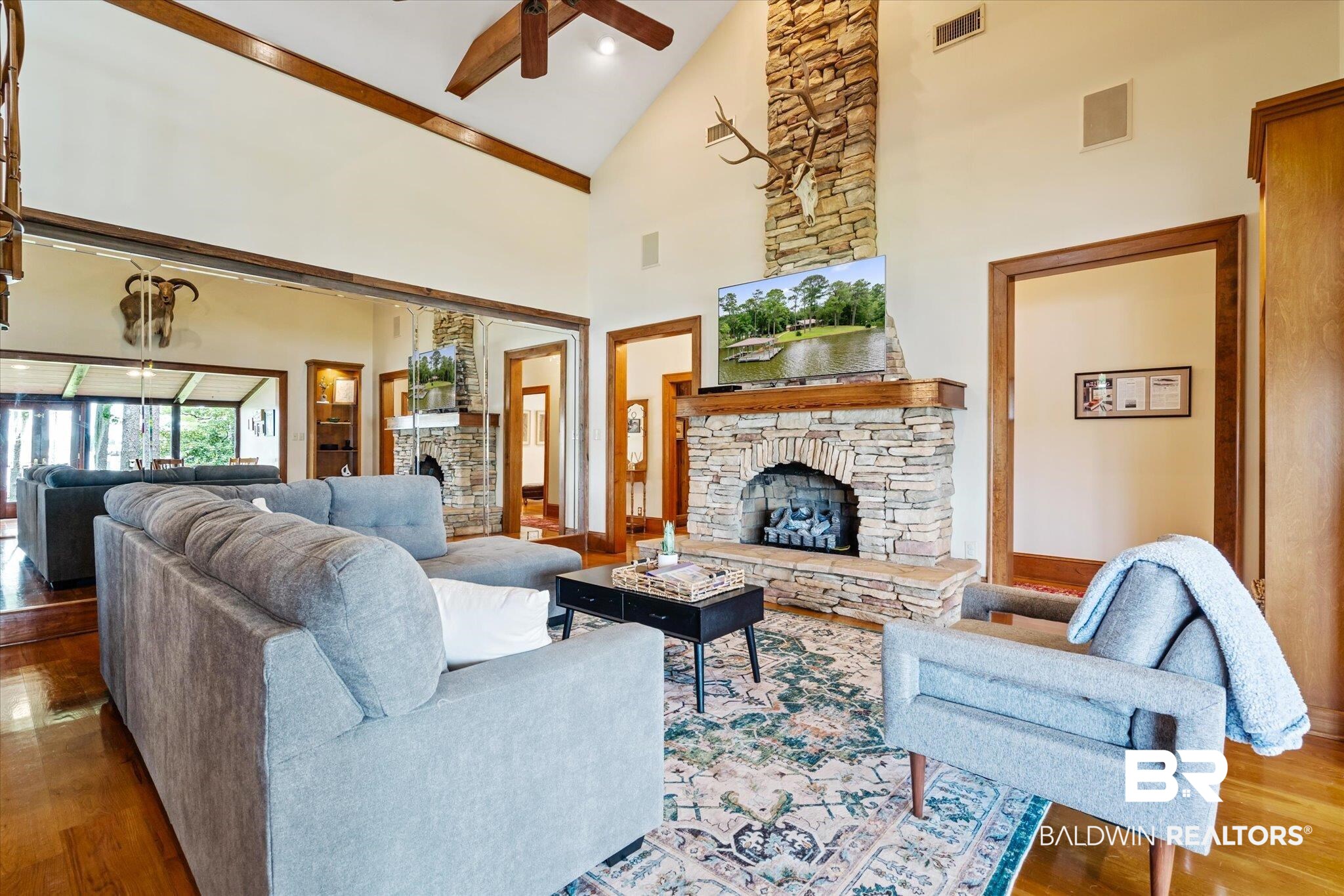2228 Riverside Drive Mobile, AL 36605 - Photo 12 of 51 Living room featuring high vaulted ceiling, ceiling fan, a fireplace, and wood-type flooring