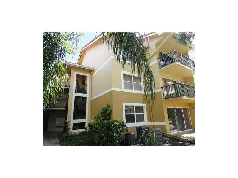 9001 Wiles Road, Unit 1033 Coral Springs, FL 33067 - Photo 2 of 11 a view of a house with a yard