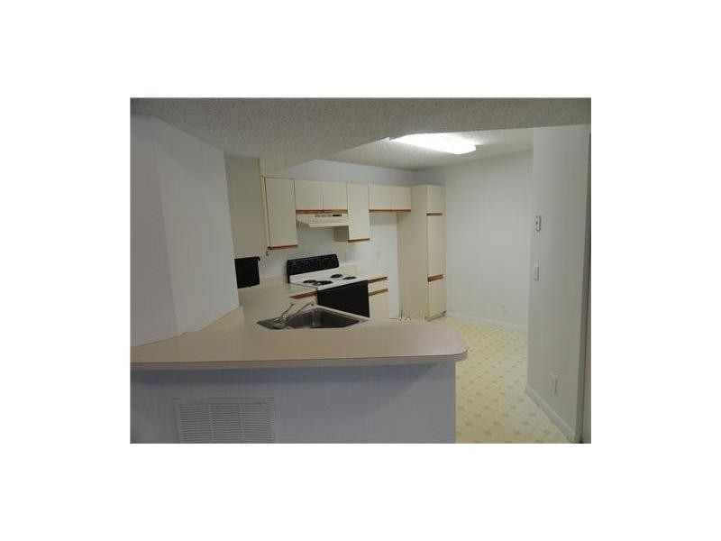 9001 Wiles Road, Unit 1033 Coral Springs, FL 33067 - Photo 3 of 11 a picture of a room with a sink