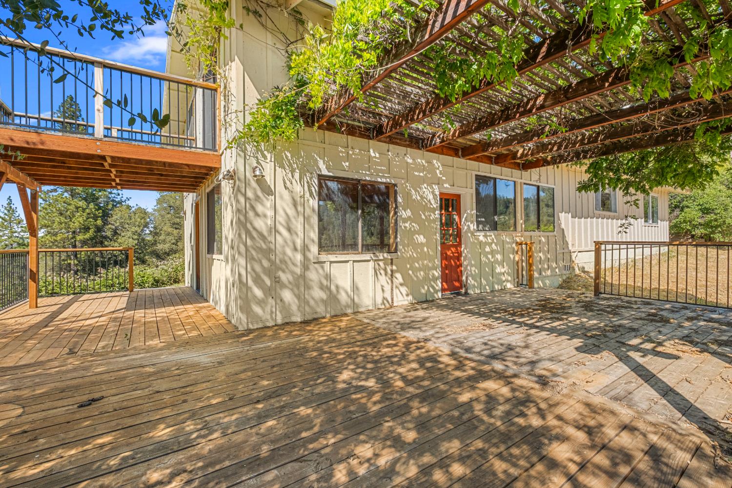 8221 Stoney Creek Road Somerset, CA 95684 - Photo 29 of 44 a view of backyard with large trees and wooden fence