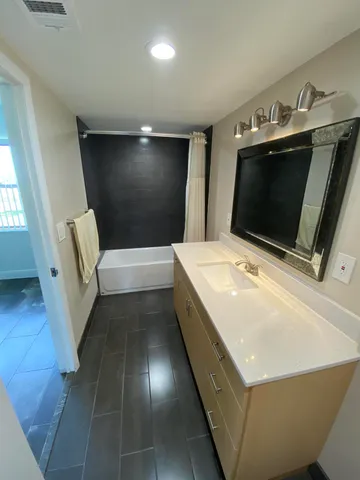 a bathroom with a sink a toilet and bathtub