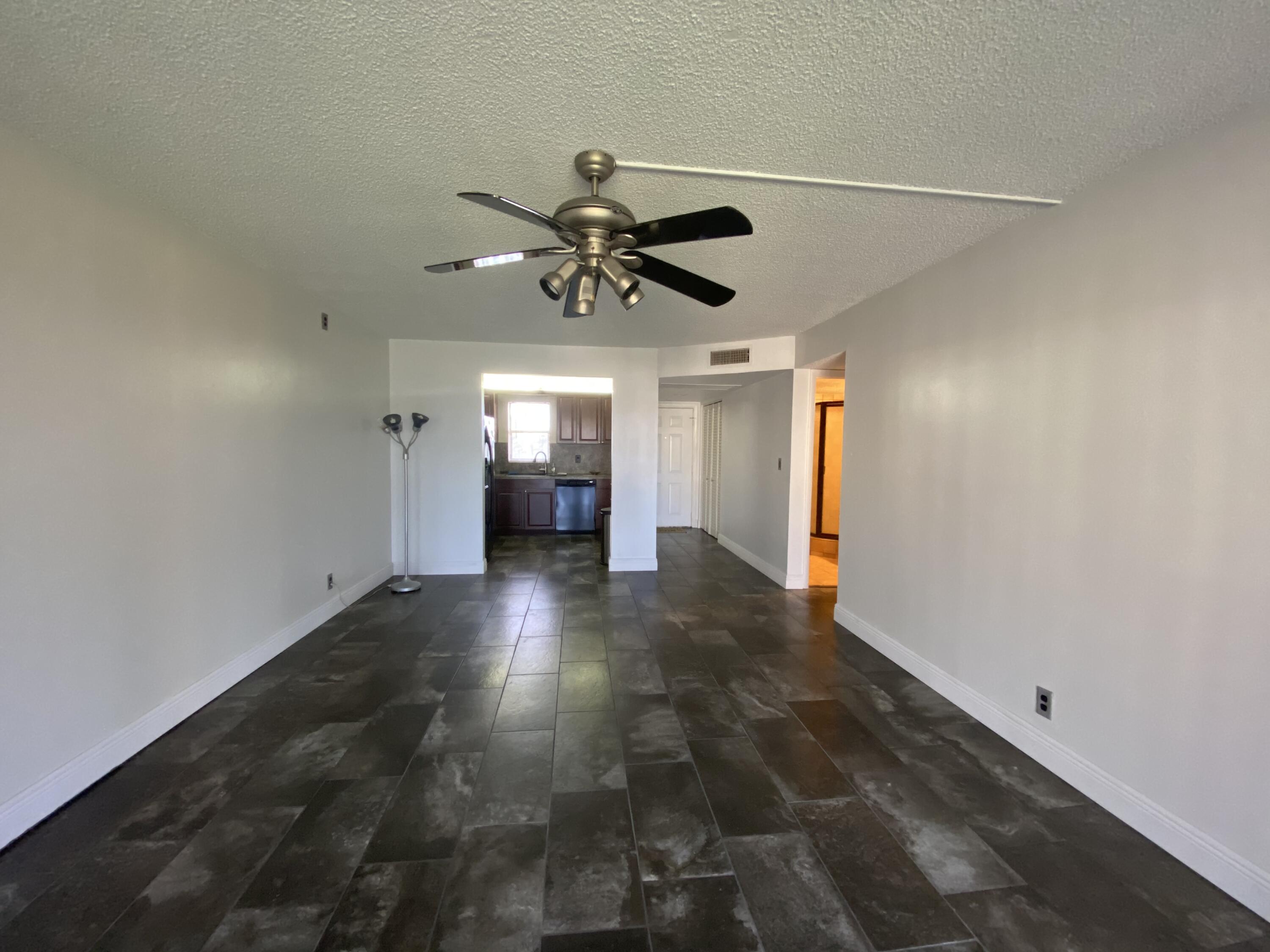 9355 Southwest 8th Street, Unit 305 Boca Raton, FL 33428 - Photo 7 of 13 a view of n empty room with a ceiling fan and window