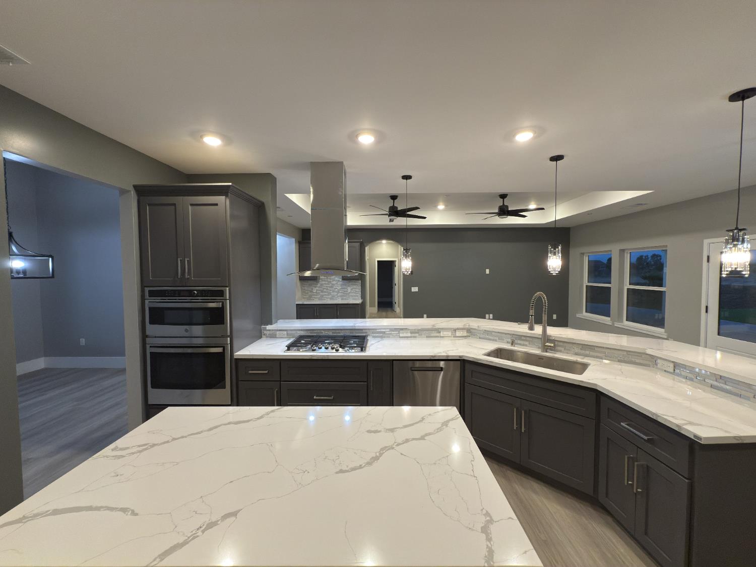 21275 Road 28 1/2 Madera, CA 93638 - Photo 11 of 28 a large kitchen with kitchen island a sink stainless steel appliances and cabinets