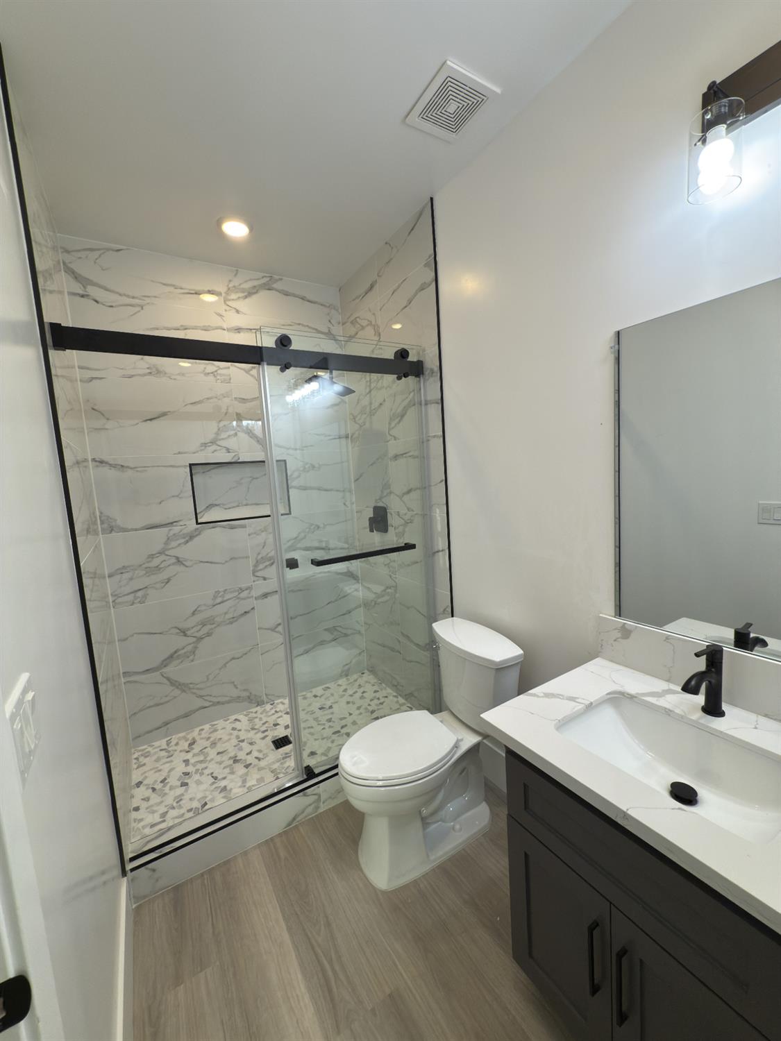 21275 Road 28 1/2 Madera, CA 93638 - Photo 16 of 28 a bathroom with a granite countertop sink toilet and shower