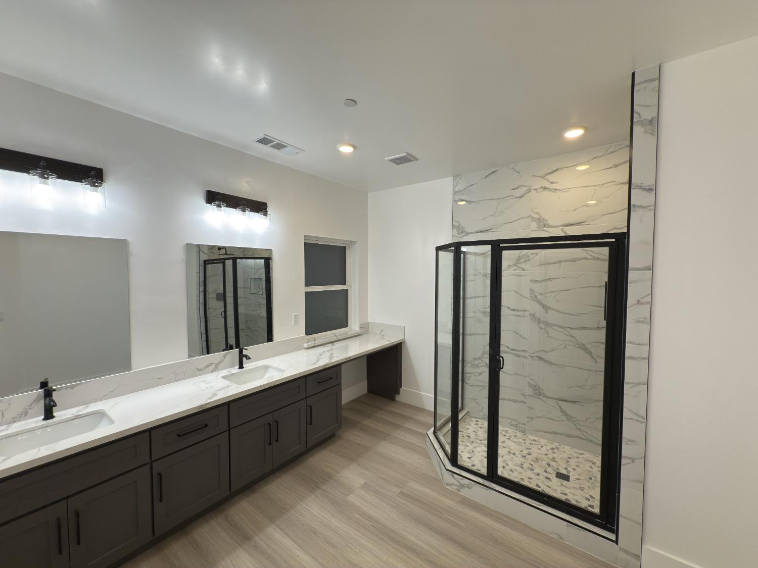 21275 Road 28 1/2 Madera, CA 93638 - Photo 26 of 28 a bathroom with double vanity sinks and a glass door shower
