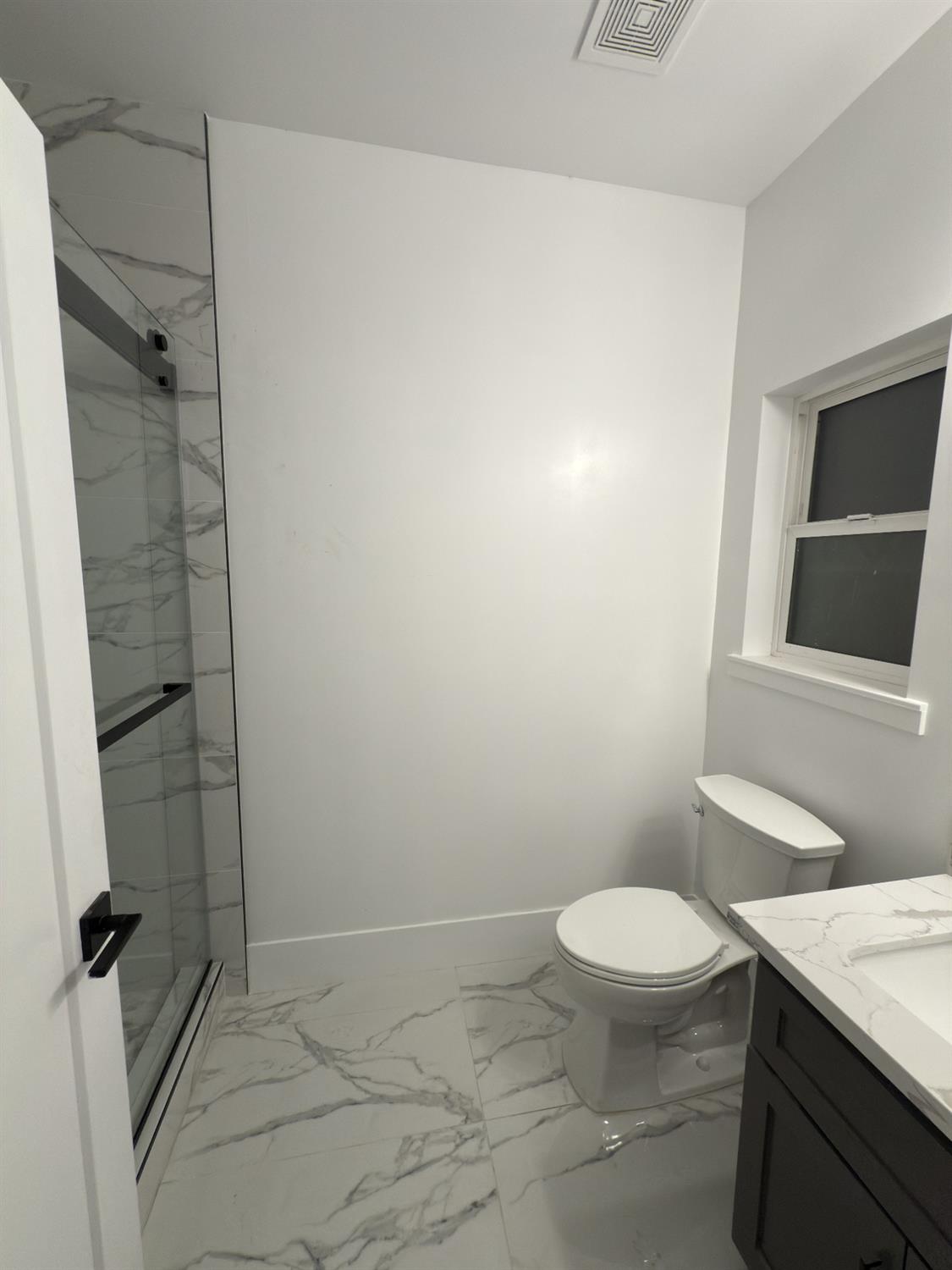 21275 Road 28 1/2 Madera, CA 93638 - Photo 27 of 28 a bathroom with a granite countertop sink toilet and shower