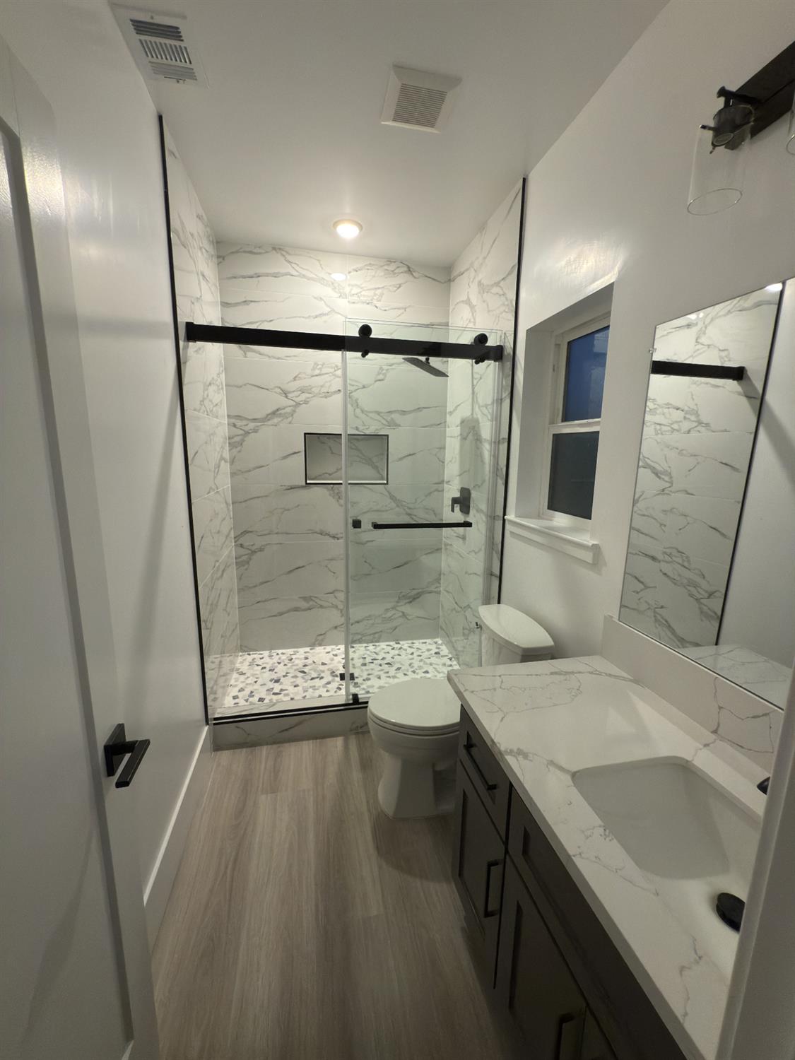 21275 Road 28 1/2 Madera, CA 93638 - Photo 28 of 28 a bathroom with a sink a toilet a mirror and shower