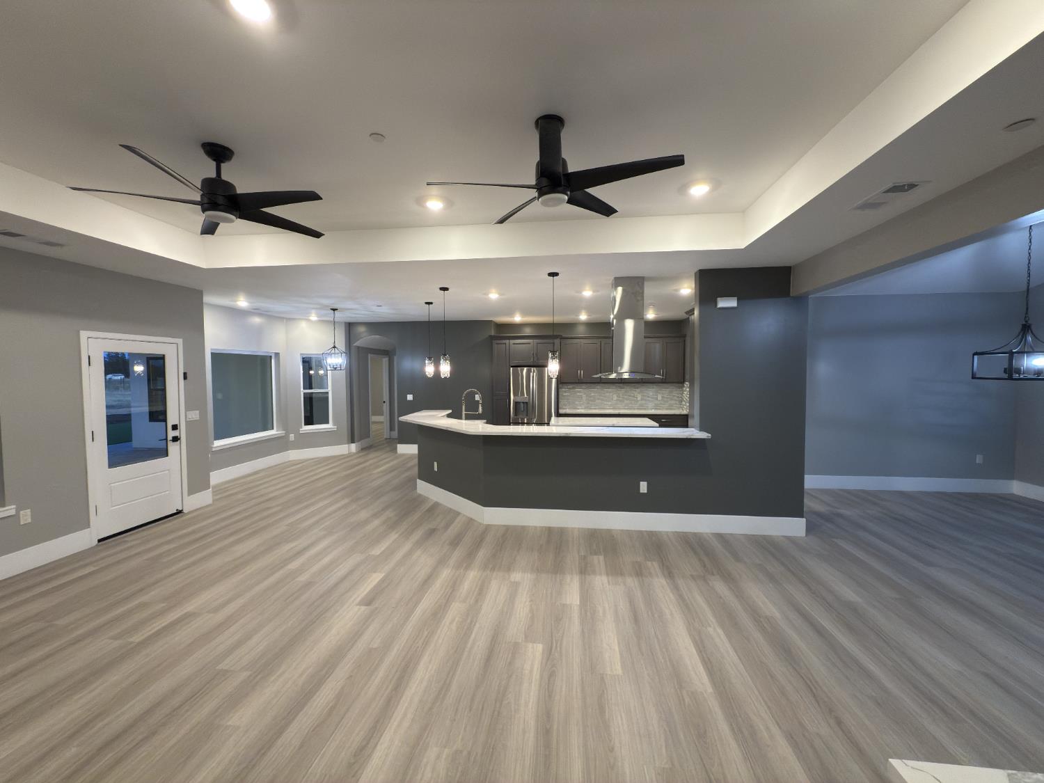 21275 Road 28 1/2 Madera, CA 93638 - Photo 8 of 28 a view of a big room with wooden floor and a ceiling fan