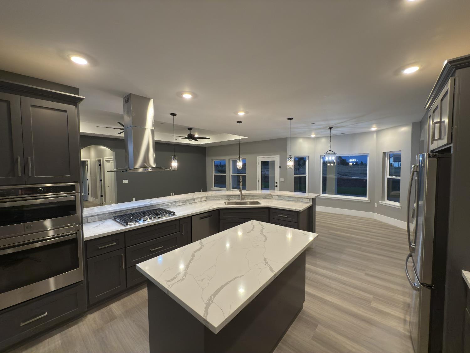 21275 Road 28 1/2 Madera, CA 93638 - Photo 10 of 28 a kitchen with stainless steel appliances granite countertop a kitchen island a stove and a refrigerator