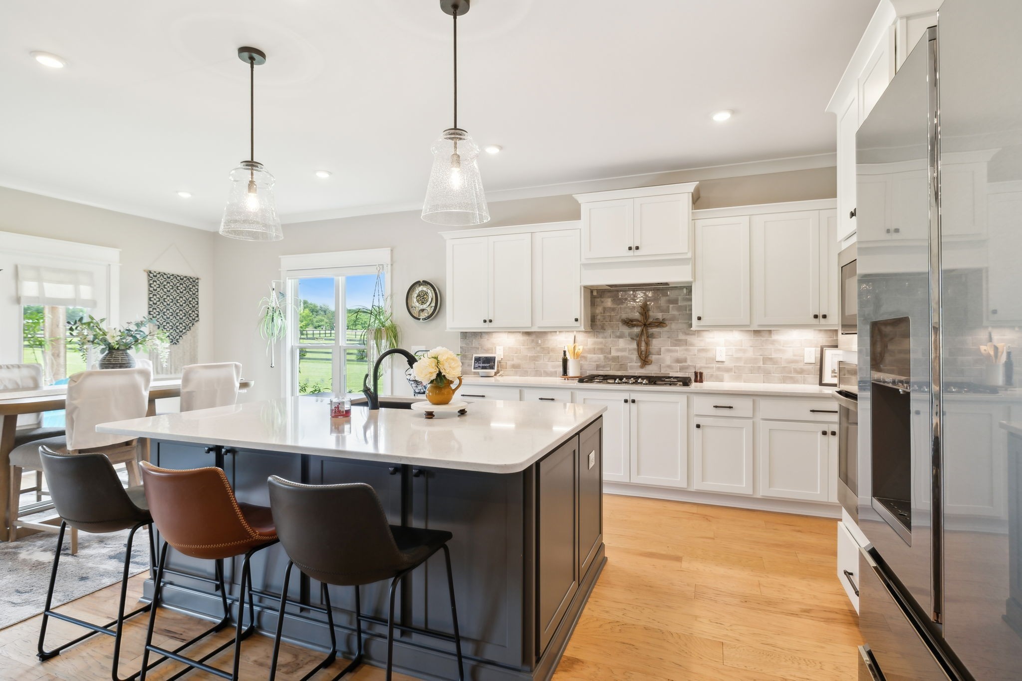 11769 Milton Street Milton, TN 37118 - Photo 12 of 77 a kitchen with stainless steel appliances kitchen island granite countertop a sink a stove a dining table and chairs