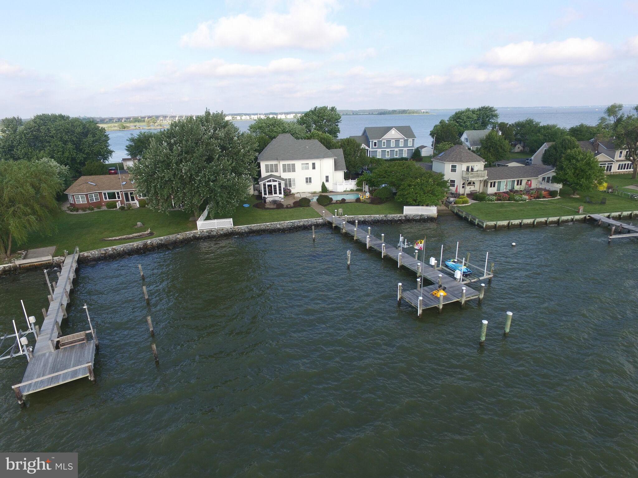 1014 Long Point Road Grasonville, MD 21638 - Photo 1 of 16 an aerial view of a house with a garden and lake view