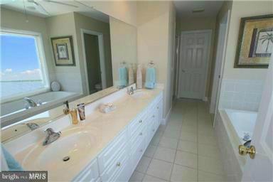 1014 Long Point Road Grasonville, MD 21638 - Photo 14 of 16 a bathroom with a double vanity sink and mirror