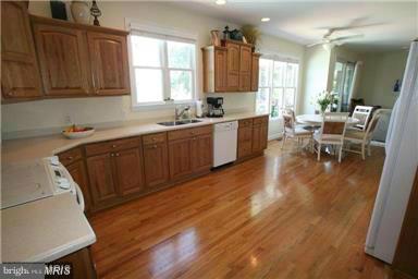 1014 Long Point Road Grasonville, MD 21638 - Photo 9 of 16 a kitchen with wooden floors sink table and chairs