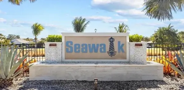 a view of a swimming pool with outdoor seating