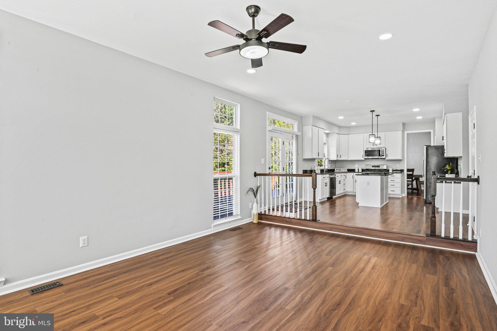 20733 Rainsboro Drive Ashburn, VA 20147 - Photo 12 of 63 a view of a kitchen with wooden floor and a window