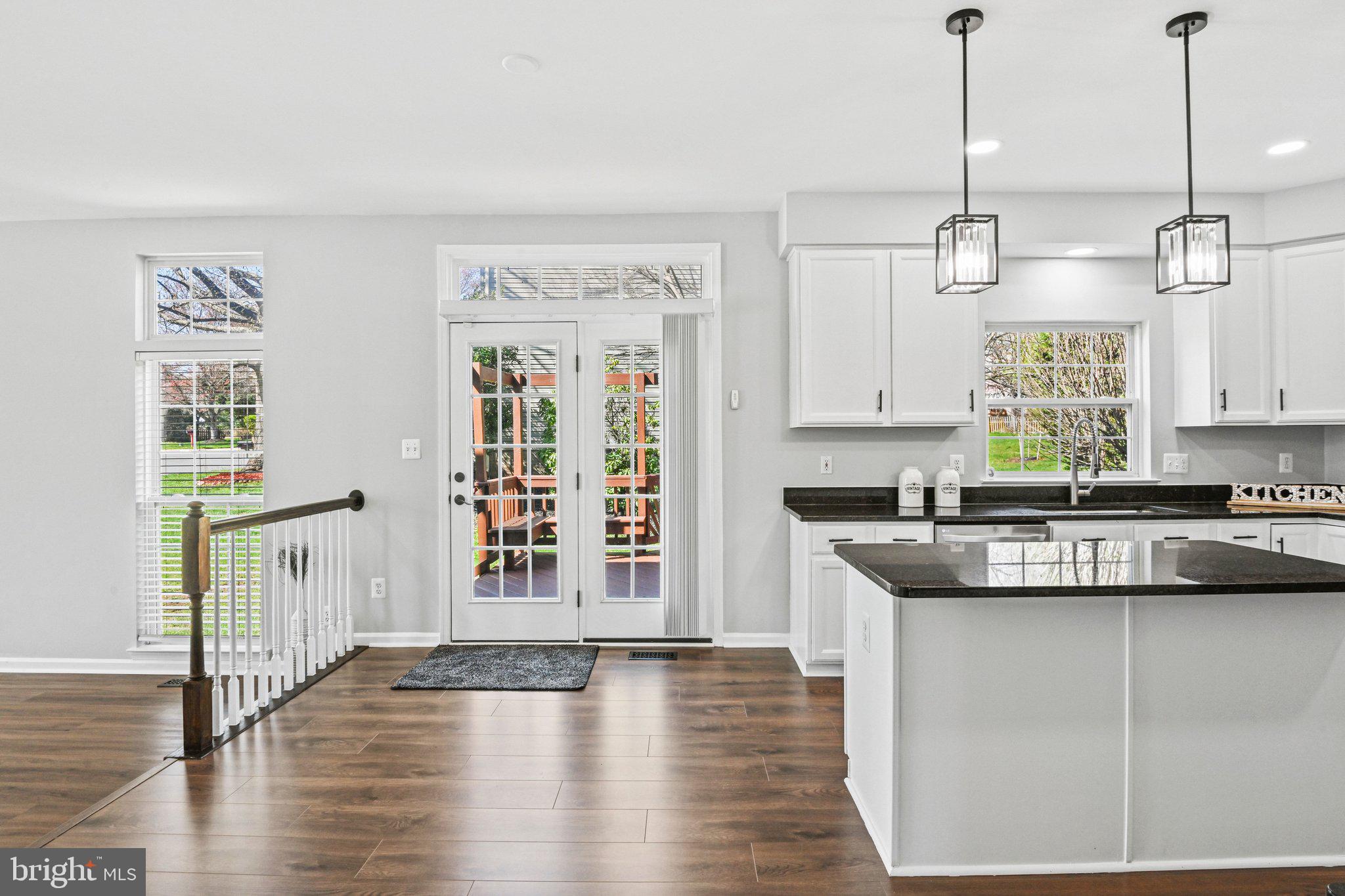 20733 Rainsboro Drive Ashburn, VA 20147 - Photo 17 of 63 a kitchen with stainless steel appliances granite countertop a sink a stove and a wooden floors