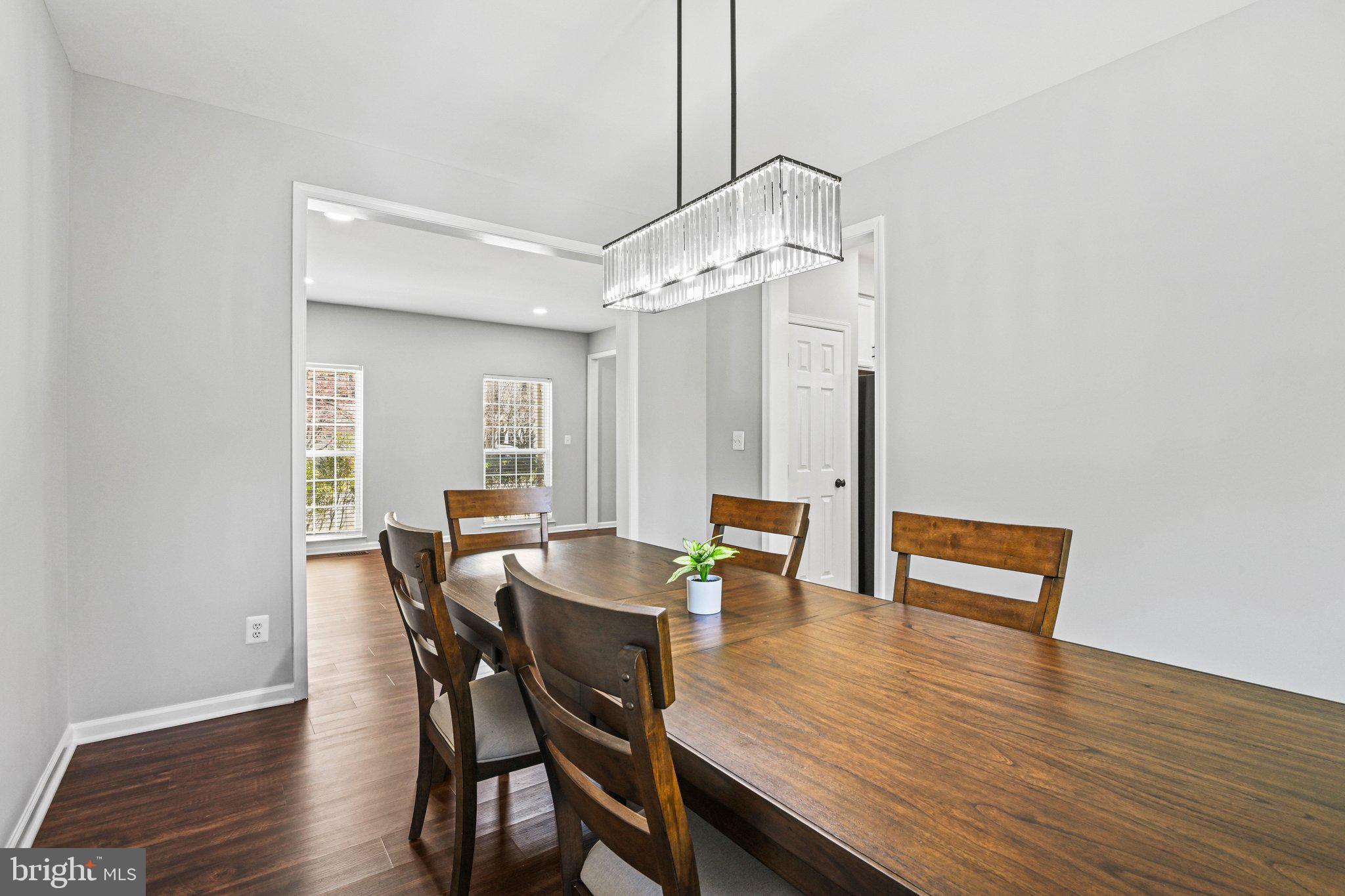 20733 Rainsboro Drive Ashburn, VA 20147 - Photo 19 of 63 a view of a dining room with furniture and wooden floor