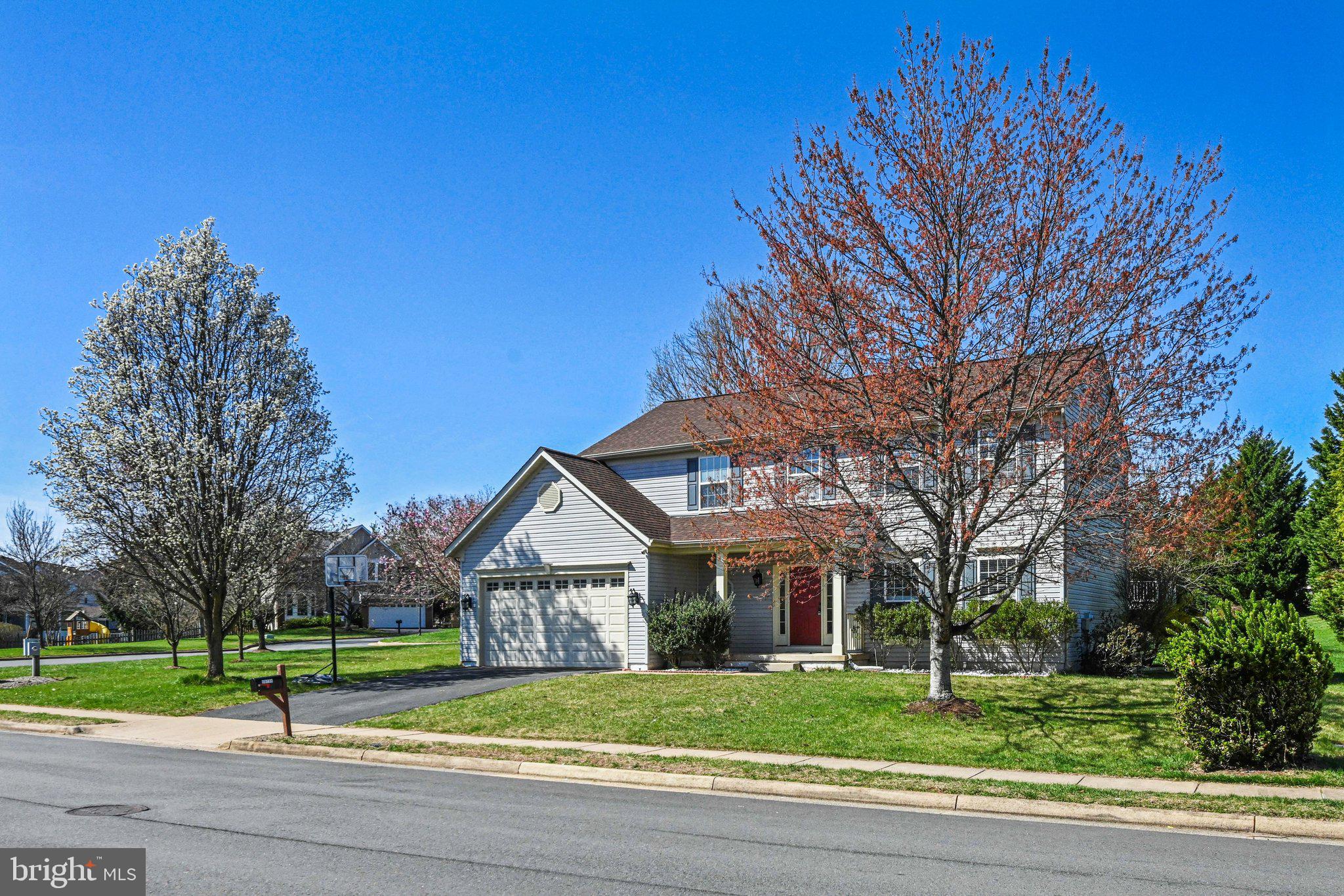 20733 Rainsboro Drive Ashburn, VA 20147 - Photo 2 of 63 a front view of a house with a yard