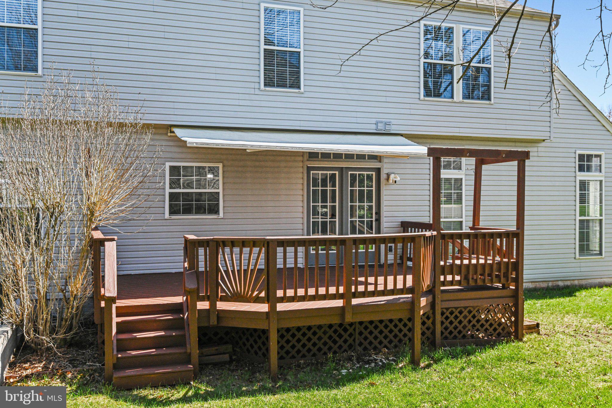 20733 Rainsboro Drive Ashburn, VA 20147 - Photo 22 of 63 a wooden bench sitting in front of a house