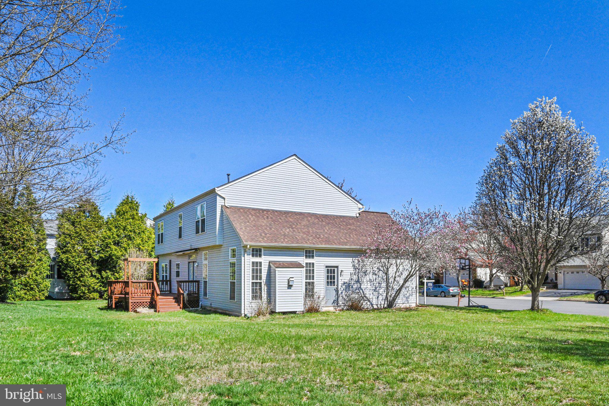 20733 Rainsboro Drive Ashburn, VA 20147 - Photo 25 of 63 a view of a house with a big yard and large trees