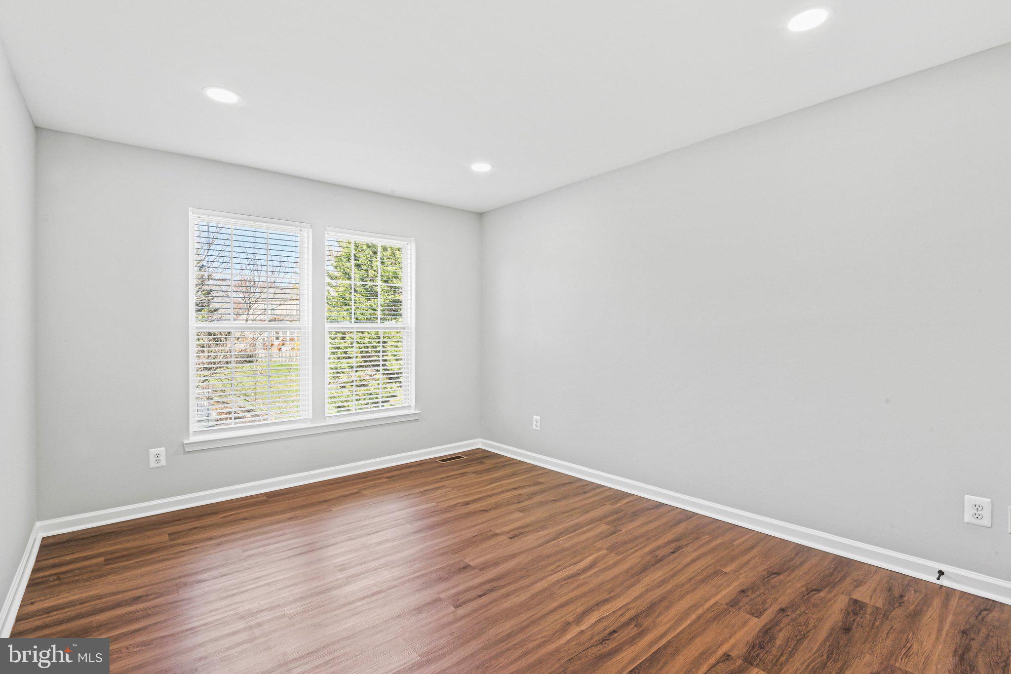 20733 Rainsboro Drive Ashburn, VA 20147 - Photo 40 of 63 an empty room with wooden floor and windows