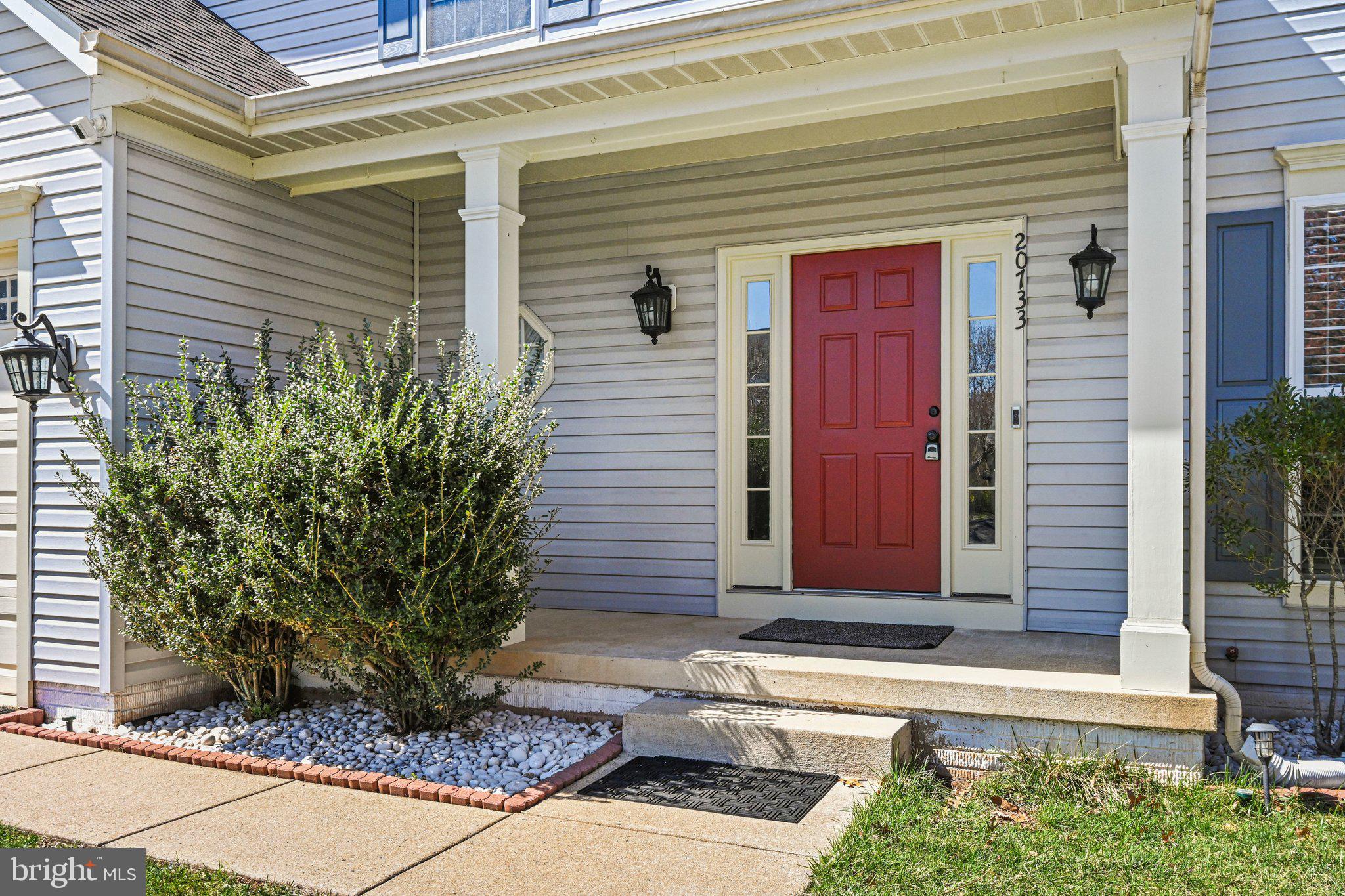 20733 Rainsboro Drive Ashburn, VA 20147 - Photo 5 of 63 a front view of a house with a yard and potted plants