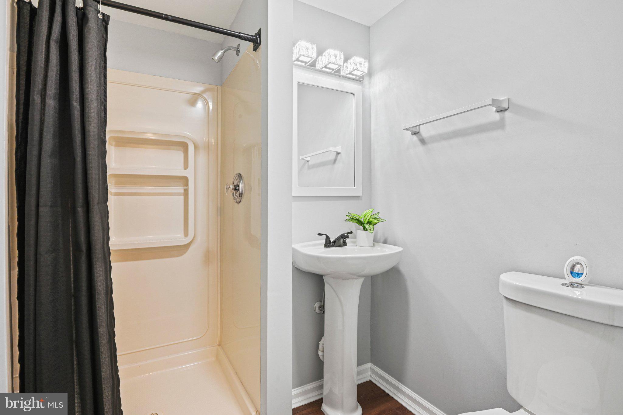 20733 Rainsboro Drive Ashburn, VA 20147 - Photo 51 of 63 a bathroom with a sink a toilet and shower