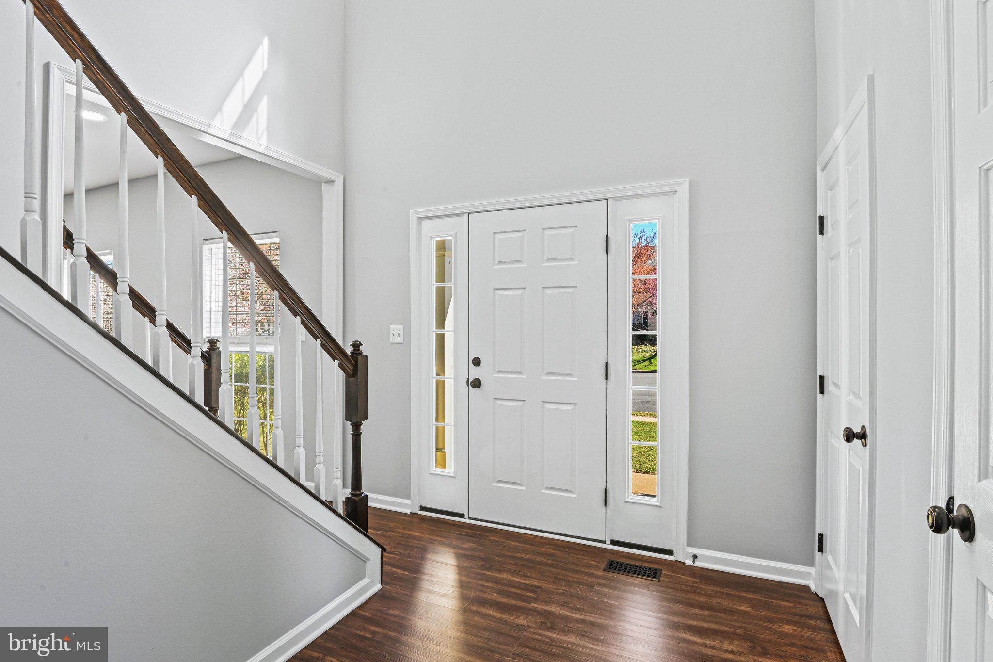 20733 Rainsboro Drive Ashburn, VA 20147 - Photo 6 of 63 a view of an entryway with wooden floor and stairs
