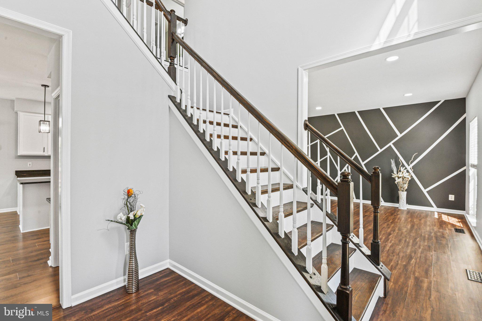 20733 Rainsboro Drive Ashburn, VA 20147 - Photo 7 of 63 a view of entryway with wooden floor and stairs