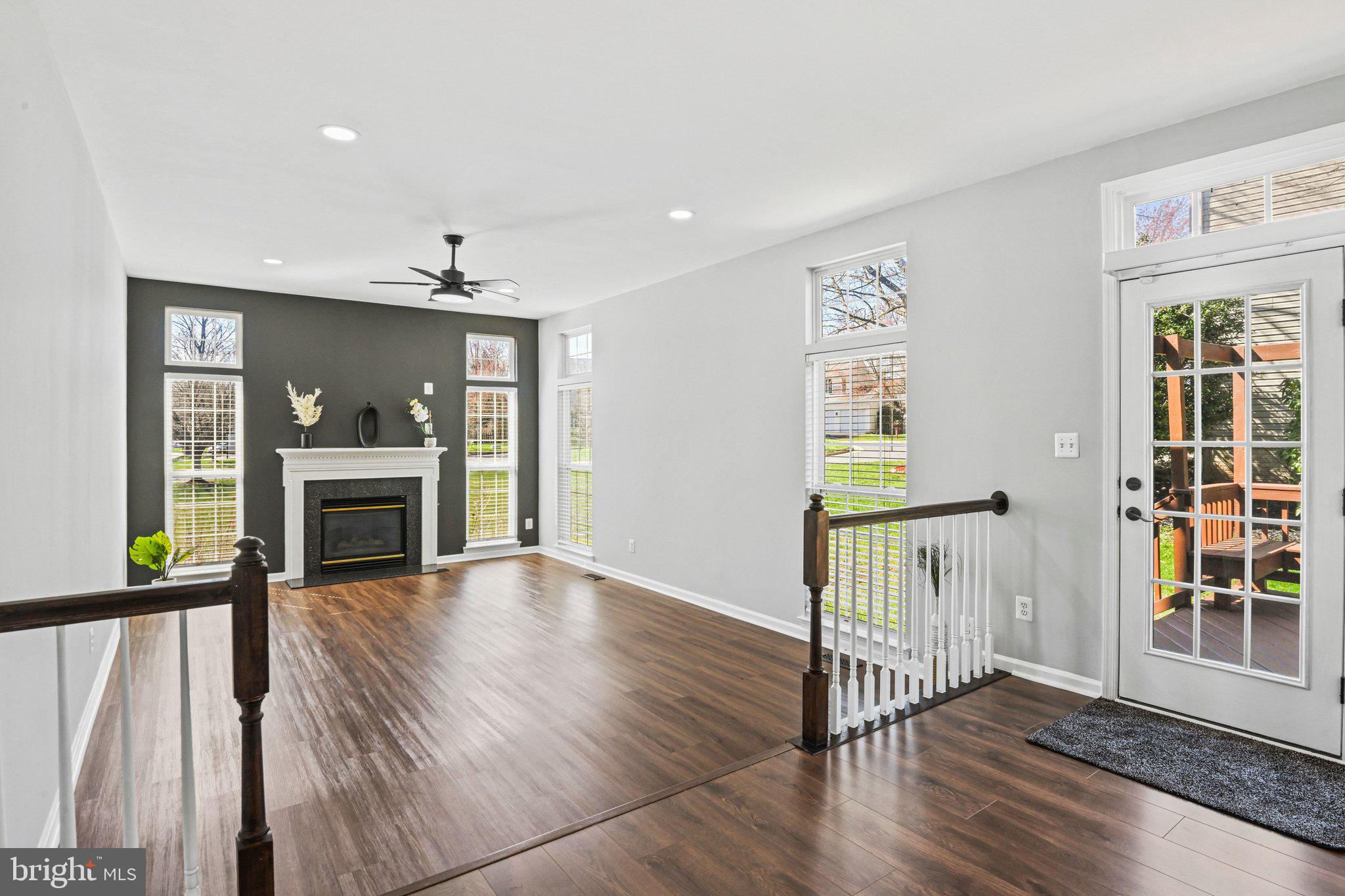 20733 Rainsboro Drive Ashburn, VA 20147 - Photo 10 of 63 a view of a hallway with wooden floor fireplace and windows