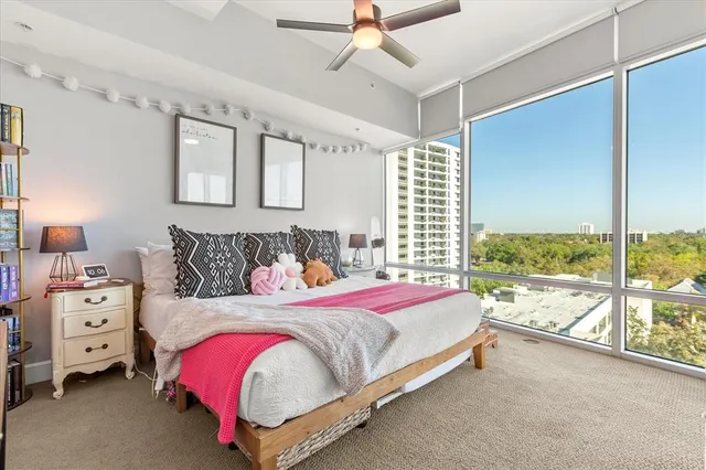 a bedroom with a bed and a large window