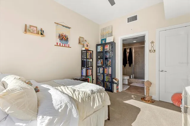a bedroom with a bed and a book shelf