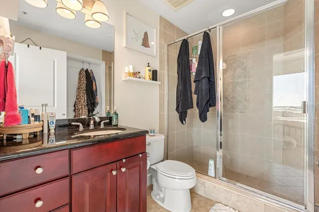 a bathroom with a sink a toilet and shower