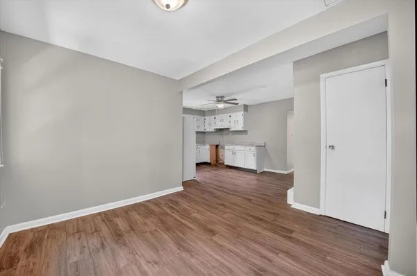 a view of a kitchen with wooden floor