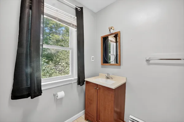 a bathroom with a sink a toilet and a window