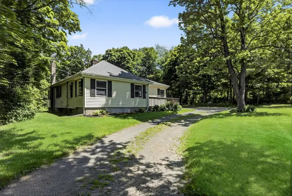 a front view of house with yard and green space